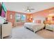 Bright bedroom features a plush bed, modern decor, and natural light, perfect for relaxation at 2116 Lelani Cir, Davenport, FL 33897
