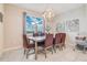 Inviting dining room has a decorative light fixture, a large window view, and contemporary decor at 2116 Lelani Cir, Davenport, FL 33897
