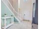 Inviting entryway features a white staircase and tiled floor, complemented by neutral wall tones at 2116 Lelani Cir, Davenport, FL 33897