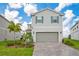 Charming two-story home with light gray siding, blue shutters, and a meticulously paved driveway at 2116 Lelani Cir, Davenport, FL 33897