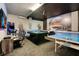Entertaining game room featuring ping pong, pool table, and Star Wars decorations on the walls at 2116 Lelani Cir, Davenport, FL 33897