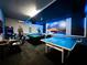 Well-lit game room featuring ping pong table, pool table, Star Wars wall art, and game console at 2116 Lelani Cir, Davenport, FL 33897