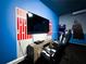 Gaming area features cool blue wall accents, comfortable gaming chairs and TV for immersive play at 2116 Lelani Cir, Davenport, FL 33897