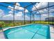 A spacious, screened-in swimming pool offers a private oasis with neighborhood views at 2116 Lelani Cir, Davenport, FL 33897