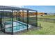 A private backyard pool with screened enclosure shows a serene and inviting space at 2116 Lelani Cir, Davenport, FL 33897