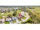 Charming neighborhood view featuring well-maintained homes, lush landscaping, and a nearby lake at 2126 Sansores St, The Villages, FL 32159