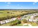 Expansive aerial view showcasing the home's location near a golf course and equestrian training facility at 2126 Sansores St, The Villages, FL 32159