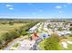 Overhead image displays a residential neighborhood surrounding a golf course with scenic views at 2126 Sansores St, The Villages, FL 32159