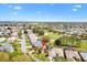 Aerial view of a home with a screened-in pool located on a golf course at 2126 Sansores St, The Villages, FL 32159