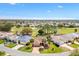 Aerial view of a home nestled in a golf course community with lush greenery and serene surroundings at 2126 Sansores St, The Villages, FL 32159