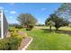 Lush backyard landscaping and an adjacent golf course provide an exceptional outdoor experience at 2126 Sansores St, The Villages, FL 32159