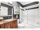 Bathroom with a marble countertop vanity and a tub-shower combination with sliding glass door at 2126 Sansores St, The Villages, FL 32159