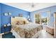 A comfortable bedroom with a ceiling fan and a sunny window overlooking the pool at 2126 Sansores St, The Villages, FL 32159