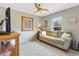 Comfortable bedroom with a ceiling fan, a plush rug, and a comfortable sofa at 2126 Sansores St, The Villages, FL 32159
