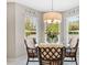 Charming breakfast nook with large windows, a round glass table, and seating for four, perfect for casual dining at 2126 Sansores St, The Villages, FL 32159