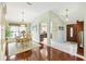 Open concept dining room adjacent to foyer features dark hardwood floors and ample natural light at 2126 Sansores St, The Villages, FL 32159