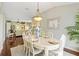 Dining room with hardwood floors, china cabinet, seating for six, and lots of natural light at 2126 Sansores St, The Villages, FL 32159