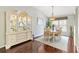 Elegant dining room with hardwood floors, a large china cabinet, and a table with seating for six at 2126 Sansores St, The Villages, FL 32159