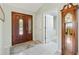 Inviting foyer with elegant front door, tile floors, and coat closet at 2126 Sansores St, The Villages, FL 32159