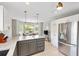 Bright kitchen featuring stainless steel appliances, granite countertops, and a breakfast nook with ample natural light at 2126 Sansores St, The Villages, FL 32159