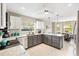 Bright kitchen boasts granite countertops, stainless appliances, and island with seating at 2126 Sansores St, The Villages, FL 32159