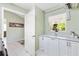 Well-lit laundry room with white cabinets, a marble countertop, and a convenient hanging rod at 2126 Sansores St, The Villages, FL 32159