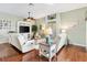 Cozy living room with hardwood floors, comfortable seating, built-in shelving, and plenty of natural light at 2126 Sansores St, The Villages, FL 32159