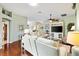 Open concept living room with hardwood floors, comfortable seating, and a media center with a large television at 2126 Sansores St, The Villages, FL 32159