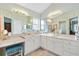 A bright main bathroom featuring dual sinks, white cabinets, and lots of counterspace at 2126 Sansores St, The Villages, FL 32159