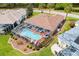 Beautiful aerial view of the home's pool with screen enclosure, perfect for outdoor enjoyment at 2126 Sansores St, The Villages, FL 32159