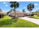 Beautiful tan home with well manicured lawn and mature palm trees at 2126 Sansores St, The Villages, FL 32159