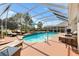 Inviting screened-in pool area with lounge chairs and outdoor dining, perfect for relaxation and entertainment at 2126 Sansores St, The Villages, FL 32159