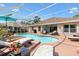 Beautiful screened-in pool with lounge chairs and an umbrella-covered table on the patio for relaxed enjoyment at 2126 Sansores St, The Villages, FL 32159