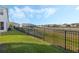 Lush backyard with black metal fence offers privacy and scenic views at 213 Primrose Dr, Davenport, FL 33837