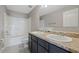 Bathroom featuring a double vanity with a granite countertop, and a shower tub combo at 213 Primrose Dr, Davenport, FL 33837