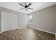 Light-filled bedroom with double door closet, neutral paint, and wood-look flooring at 213 Primrose Dr, Davenport, FL 33837