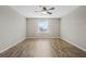 Spacious bedroom featuring wood-look floors, a ceiling fan, and plenty of natural light at 213 Primrose Dr, Davenport, FL 33837