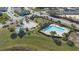 Aerial view of the community pool, playground, and surrounding landscaping at 213 Primrose Dr, Davenport, FL 33837