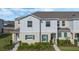Attractive townhouse featuring well-kept landscaping, neutral color palette, and a welcoming facade at 213 Primrose Dr, Davenport, FL 33837