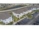 Exterior view of townhouse and lush landscaping under a bright sunny day with parking at 213 Primrose Dr, Davenport, FL 33837