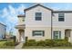 Charming two-story home featuring neutral siding, green shutters, and well-maintained front yard landscaping at 213 Primrose Dr, Davenport, FL 33837