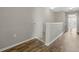 Hallway with wood floors and white trim, leading to another room with ceiling fan at 213 Primrose Dr, Davenport, FL 33837