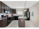 Well-lit kitchen featuring black appliances, granite countertops, and a functional center island at 213 Primrose Dr, Davenport, FL 33837