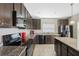 Modern kitchen with black appliances, granite countertops, and sleek cabinetry at 213 Primrose Dr, Davenport, FL 33837
