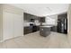 Spacious kitchen boasting dark cabinets, granite counters, black appliances, and ample storage at 213 Primrose Dr, Davenport, FL 33837