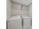 Clean laundry room features a Whirlpool washer and dryer with shelving at 213 Primrose Dr, Davenport, FL 33837