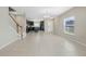 Open living area with tile flooring, leading to the kitchen with dark wood cabinets at 213 Primrose Dr, Davenport, FL 33837