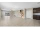 Spacious living room with tile flooring, stairs, and sliding glass doors leading to an enclosed patio at 213 Primrose Dr, Davenport, FL 33837