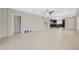 Open-concept living room with tile floors, ceiling fan, and access to the kitchen and dining area at 213 Primrose Dr, Davenport, FL 33837