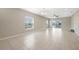 Bright living room featuring tile floors, large windows with blinds, and sliding glass doors at 213 Primrose Dr, Davenport, FL 33837